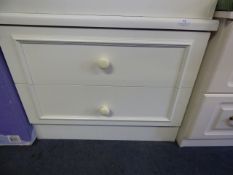 White chest of two drawers with white porcelain handles