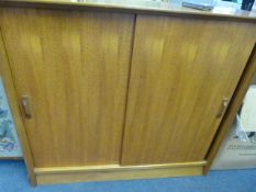 Teak cupboard enclosed by sliding doors