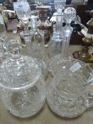 Six pieces of cut glassware including four decanters, jug and a lidded container