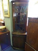 Mahogany reproduction corner cabinet with glass door