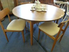 Extending circular dining table with four chairs