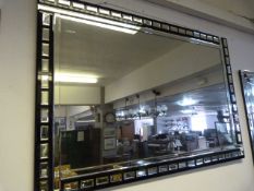 Bevelled glass wall mirror with black glass frame