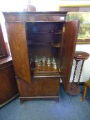 Reproduction figured mahogany drinks cabinet with string inlaid detail, containing a collection of