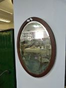 Mahogany framed oval glass mirror