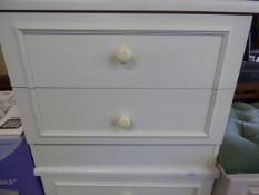 White chest of two drawers with white porcelain handles