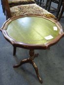 Circular wine table on tripod base with inlet leather top and pie crust edge