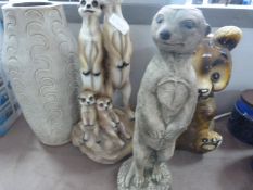 Two meercat decorations and a teddy bear