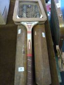 two early cricket bats and a tennis racket
