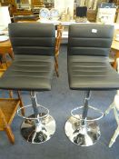 *Pair of black and chrome gas lift bar stools