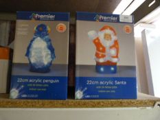Three acrylic santa led lights and four acrylic penguin led lights