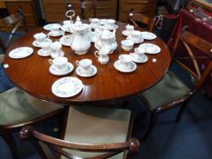 Circular Mahogany Dining Table with Six Upholstered Dinning Chairs