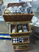 Four Tier Wicker Basket Display Containing Various Flavored Teas, Stainless Steelware, Soft