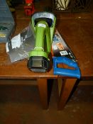 Hand Saw and a Cordless Hedge Trimmer