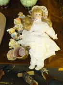 Porcelain Headed Doll with Decorative Teddy Bears and a Miniature Cottage