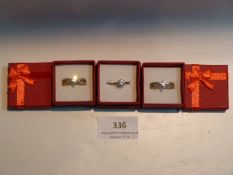 THREE SILVER METAL DRESS RINGS WITH INSET STONES