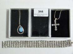 TWO WHITE METAL NECKLACES AND A BRACELET