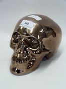 COPPER COLOURED POTTERY SKULL