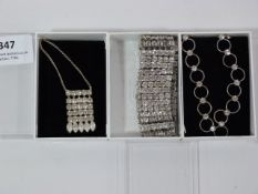 TWO WHITE METAL NECKLACES AND A CHOKER WITH INSET STONES