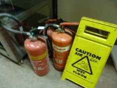 Three Fire Extinguishers and a Wet Floor Sign