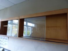 *Three Wall Mounted Wood Cabinets Enclosed By Sliding Plate Glass Doors
