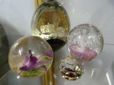 Four Glass Paperweights