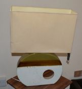 1 x Medium Sized Lamp. Concept For Living. Oval Base. White And Brown With A Cream Coloured Shade.