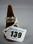 A nine carat gold eternity type ring with diamonds in a hoop channel setting (one missing), 3.1 grms