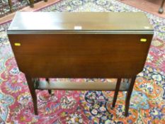 An Edwardian mahogany Sutherland table with brass and brown pot castors, 68.5 cms high, 68 cms