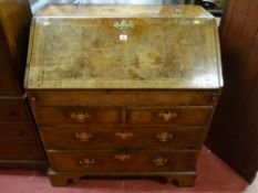 A Georgian walnut crossbanded fall front bureau, the fall opening to reveal an arrangement of