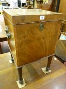 A Georgian mahogany square cellarette with carry handles on reeded supports with spade feet on brass