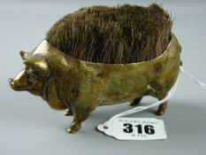 An antique brass pen nib wipe in the form of a pot bellied pig, 12 cms long