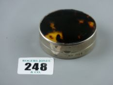 A circular silver compact having gilt interior, mirrored lid with tortoiseshell on the outside, 1.