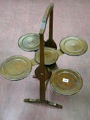 An Edwardian mahogany monoplane multi-tray folding cakestand with attached patent label