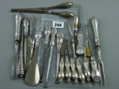A large parcel of silver handled manicure pieces, shoe horns etc, 16 ozs gross