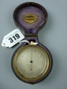 A gilt brass 19th Century pocket barometer with revolving bezel, the silvered dial marked 'Husbands,