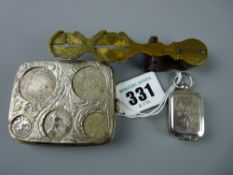 An early 20th Century white metal coin holder marked 'Patent' and 'J W B' within a shield to the