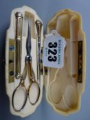 An ivory cased nécessaire, French 19th Century gilt metal sewing kit (thimble missing), 11 cms