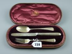 A cased three piece silver spoon knife and fork set by Hamilton & Inches, Edinburgh, 2.5 ozs,