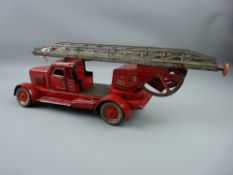 Toys - a Distler tinplate wind-up fire engine, one figure present, 45 cms long