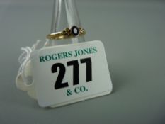 An eighteen carat gold dress ring with centre oval sapphire and two flanking diamonds, 3.6 grms