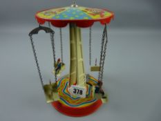 Toys - a tinplate wind-up merry-go-round made in West Germany (working)