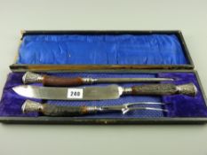 A cased three piece bone handled carving set, the handle tips and ferrules in leaf patterned silver,