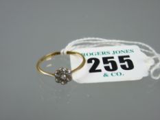 An eighteen carat gold diamond dress ring having a centre cluster of seven diamonds, 1.6 grms,