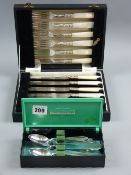 A cased set of six community plate teaspoons with sugar tongs and a cased set of mother of pearl