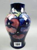A Moorcroft Pansies cobalt blue ground baluster vase, Moorcroft signature and impressed factory