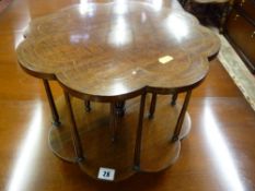 A circa 1900 inlaid mahogany tabletop revolving bookcase, petal shaped with string inlay to the top,