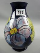 A Moorcroft Anemone deep blue ground baluster vase, 19 cms high, Moorcroft signature and impressed