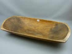 A 19th Century carved elm dough trough, 88 cms long
