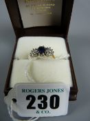 A lady's gold sapphire and diamond dress ring having a centre oval cut sapphire with two flanking