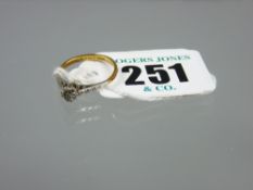 An eighteen carat gold diamond solitaire dress ring with platinum shoulders, visual estimate 0.3